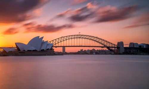 beautiful-shot-sydney-harbor-bridge-with-light-pink-blue-sky-scaled
